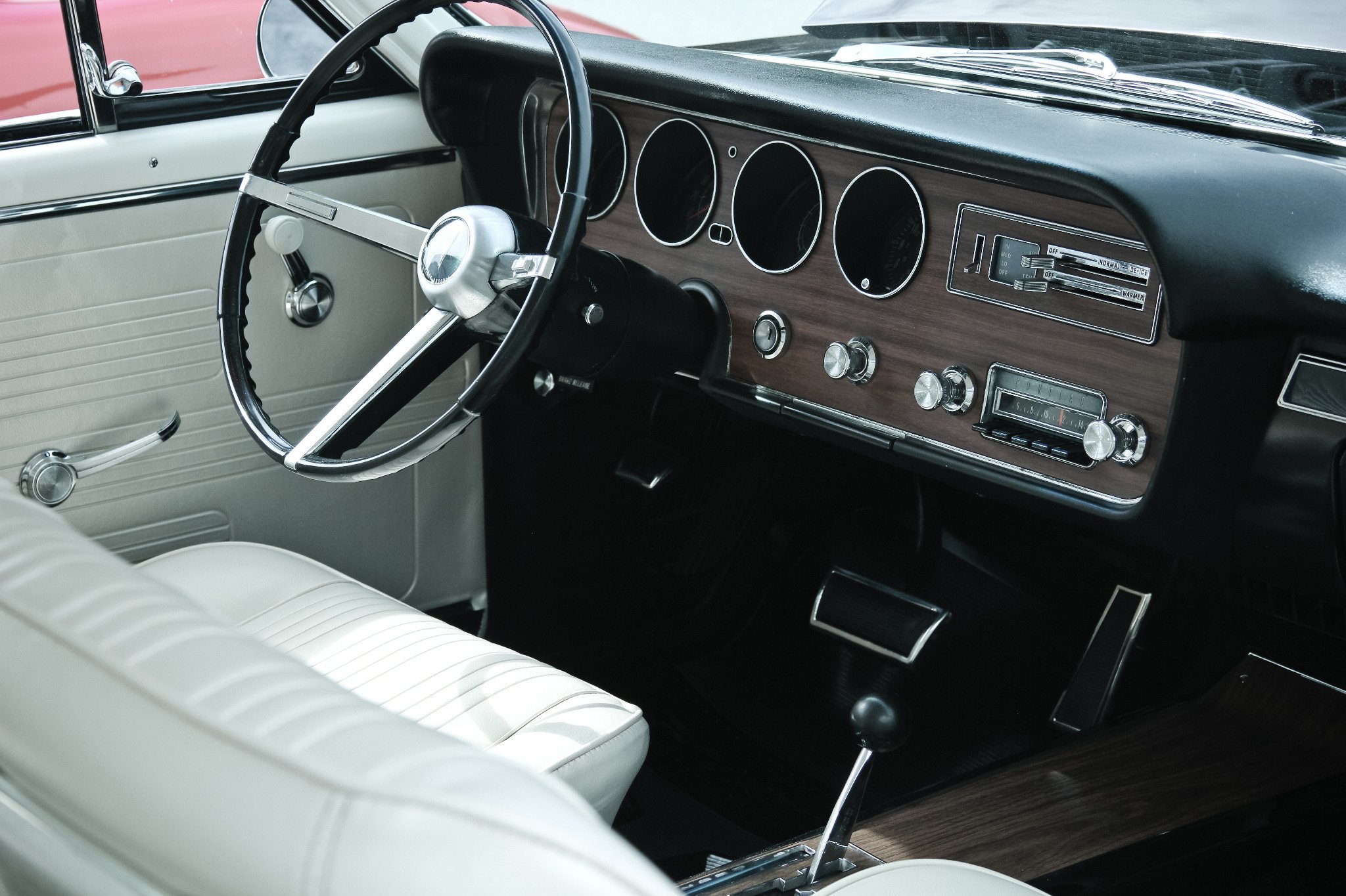 Detailed view of a vintage car dashboard and white interior